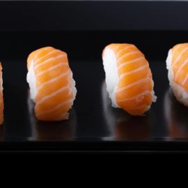 salmon sashimi - sushi - black background